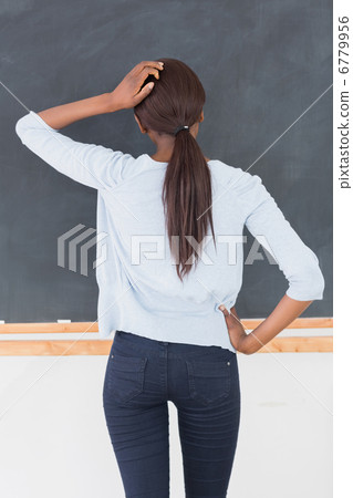 Black woman thinking in front of a blackboard Black woman thinking in front of a blackboard 6779956