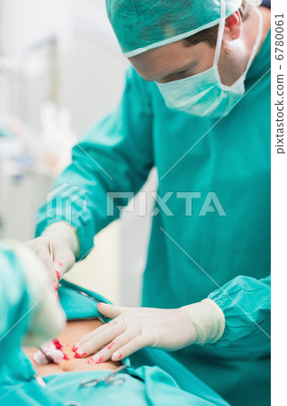 Surgeon touching at patient belly Surgeon touching at patient belly 6780061