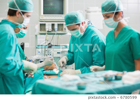 View of a surgical team operating a patient View of a surgical team operating a patient 6780599