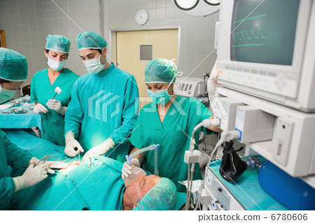 Surgical team next to a monitor 6780606