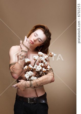 Authentic Handsome Man with Flowers standing in Studio 6783253