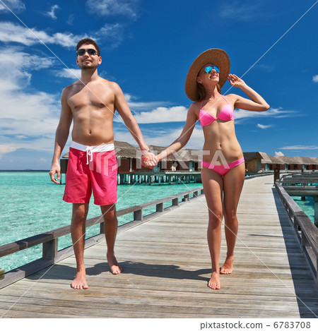 Couple on a beach jetty at Maldives 6783708