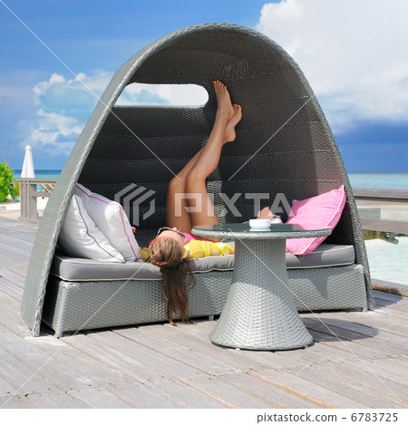 Woman on a tropical beach jetty 6783725