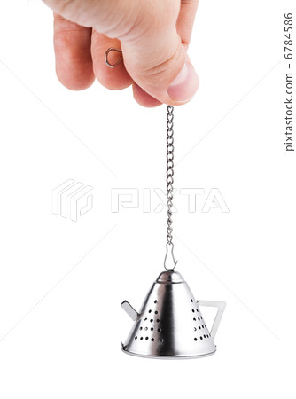 Hand holding Tea strainer, isolated on white Hand holding Tea strainer, isolated on white 6784586