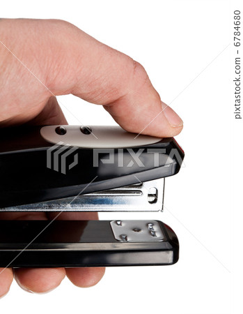 Hand holding black stapler, isolated on white Hand holding black stapler, isolated on white 6784680
