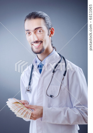 Doctor with money in studio 6811065