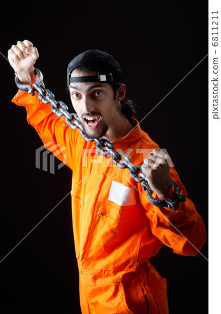 Inmate chained on black background 6811211