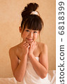 A woman wearing a bath towel 6818399