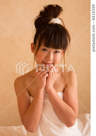 A woman wearing a bath towel 6818399
