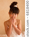 A woman wearing a bath towel 6818400