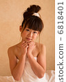 A woman wearing a bath towel 6818401