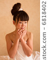 A woman wearing a bath towel 6818402