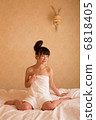 A woman wearing a bath towel 6818405