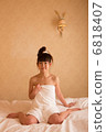 A woman wearing a bath towel 6818407