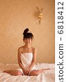 A woman wearing a bath towel 6818412