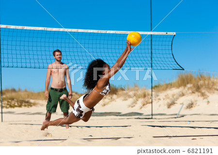 Friends playing beach volleyball 6821191
