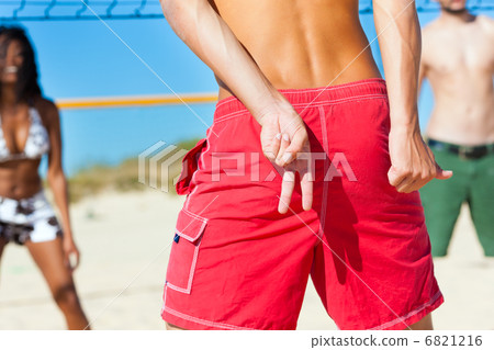 Friends playing beach volleyball 6821216