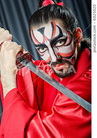 Man with face mask and sword 6825020