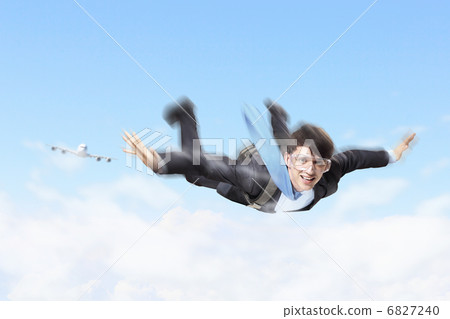 Young businessman flying with parachute on back Young businessman flying with parachute on back 6827240