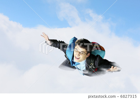 Young businessman flying with parachute on back 6827315
