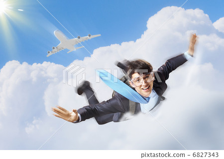 Young businessman flying with parachute on back Young businessman flying with parachute on back 6827343