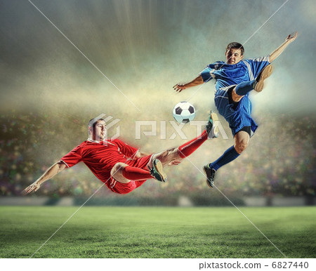 two football players striking the ball two football players striking the ball 6827440