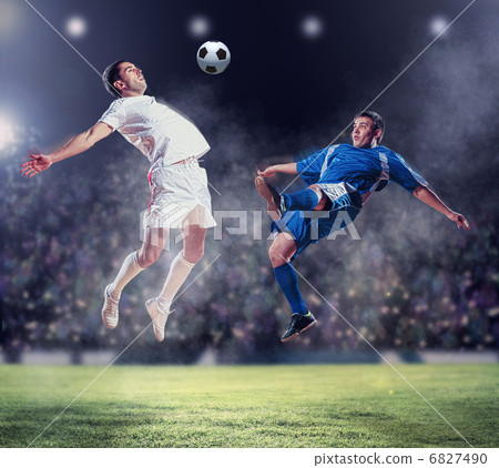 two football players striking the ball two football players striking the ball 6827490