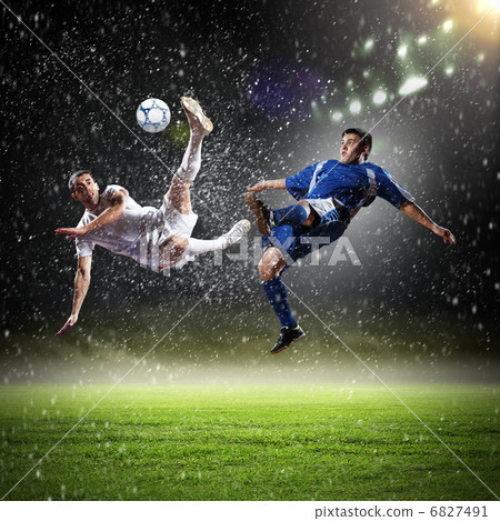 two football players striking the ball two football players striking the ball 6827491
