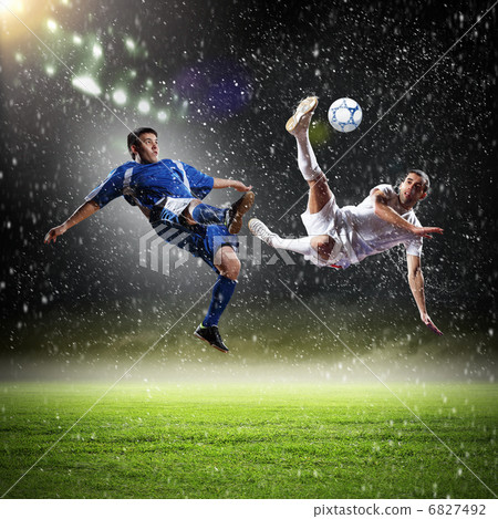 two football players striking the ball 6827492