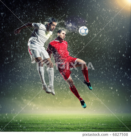 two football players striking the ball two football players striking the ball 6827508