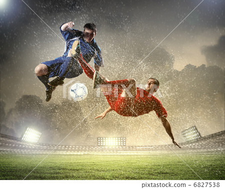 two football players striking the ball two football players striking the ball 6827538