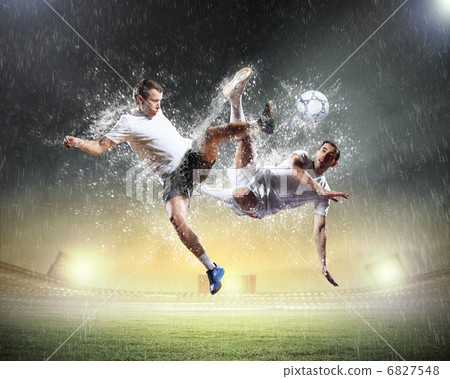 two football players striking the ball two football players striking the ball 6827548