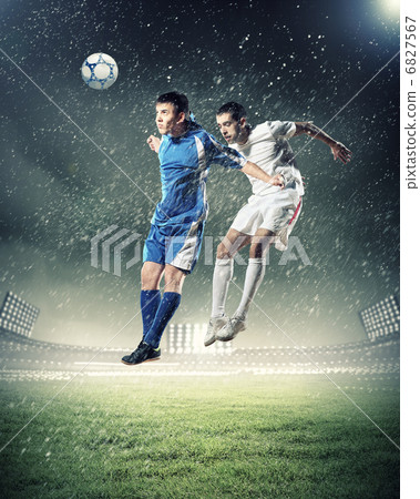 two football players striking the ball two football players striking the ball 6827567