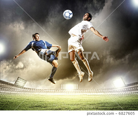 two football players striking the ball two football players striking the ball 6827605