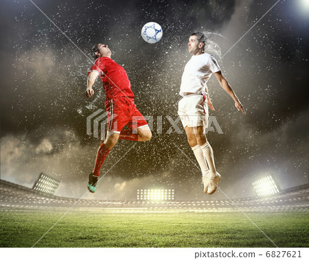 two football players striking the ball two football players striking the ball 6827621