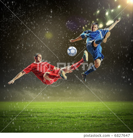 two football players striking the ball two football players striking the ball 6827647