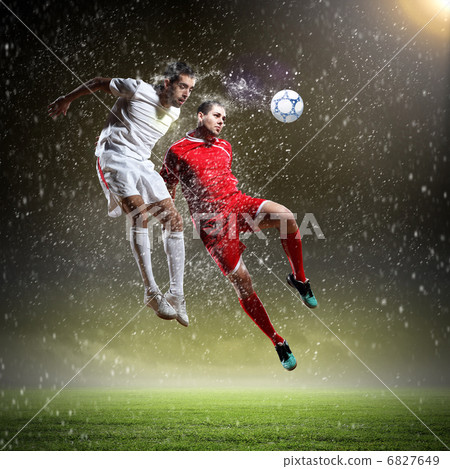 two football players striking the ball two football players striking the ball 6827649