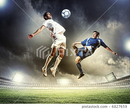 two football players striking the ball two football players striking the ball 6827659