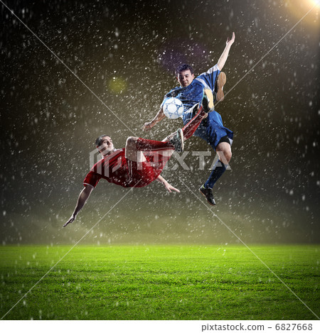 two football players striking the ball two football players striking the ball 6827668