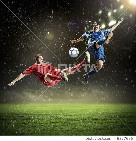 two football players striking the ball two football players striking the ball 6827686