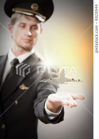 Image of pilot with plane in hand Image of pilot with plane in hand 6828944
