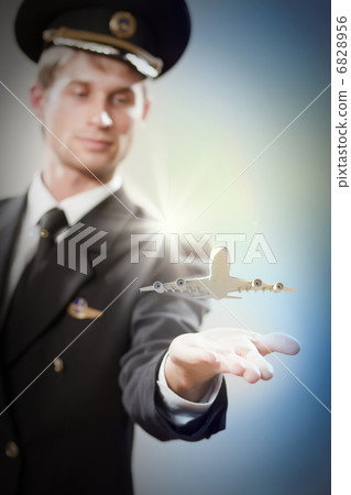 Image of pilot with plane in hand 6828956