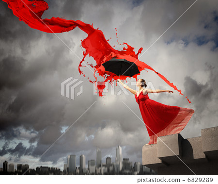 Ballet dancer in flying satin dress with umbrella 6829289