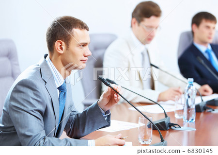 Three businesspeople at meeting 6830145