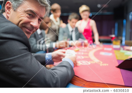 Man smiling at the poker table Man smiling at the poker table 6830810