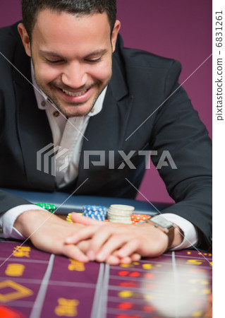 Man happily grabbing chips 6831261