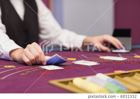 Dealer distributing cards at table Dealer distributing cards at table 6831332