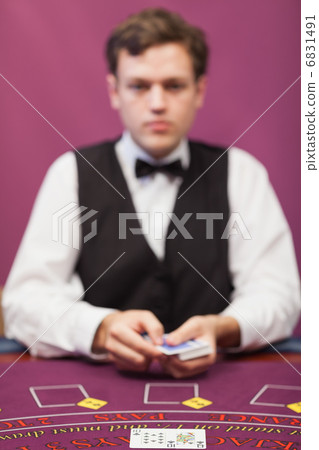 Dealer about to deal in poker game 6831491