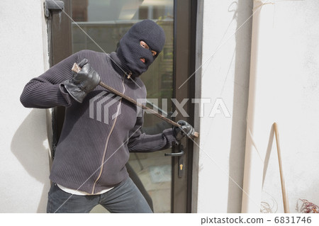 Robber breaking into house using crow bar Robber breaking into house using crow bar 6831746