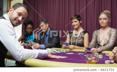Dealer smiling at poker game 6831755